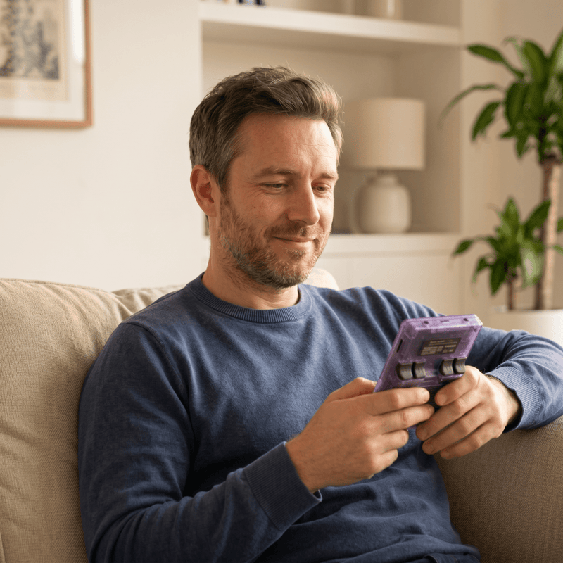 Person playing the RetroVerse Pro 2.0 R36S retro gaming console at home